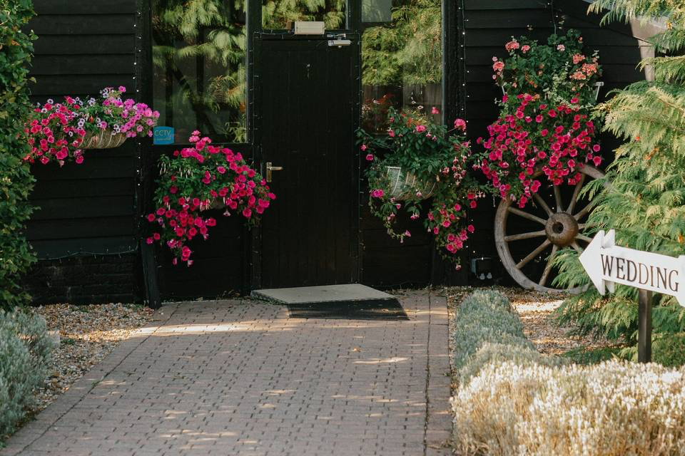 Venue entrance with flowers and wedding sign