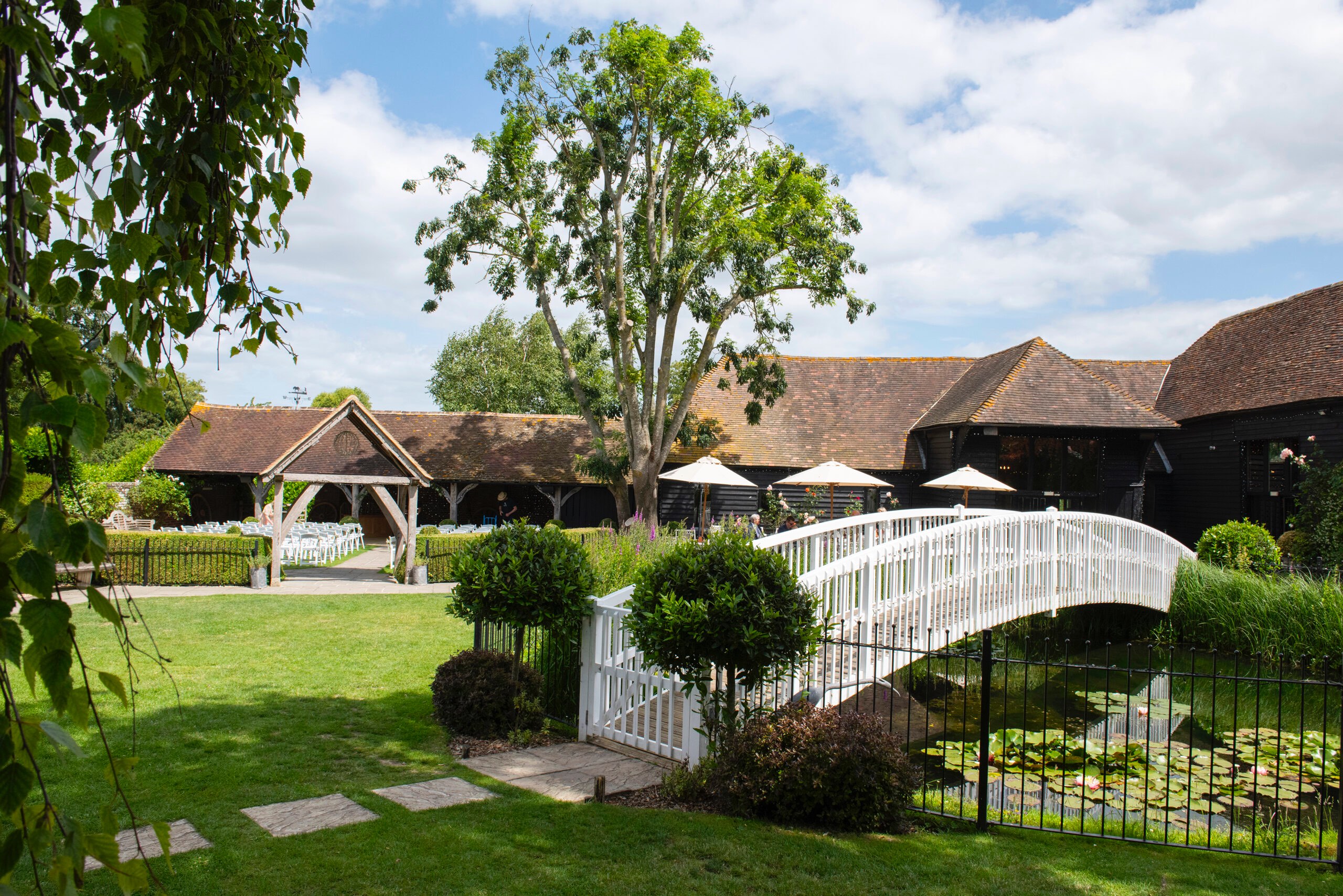 Winters Barns venue exterior with gardens and bridge